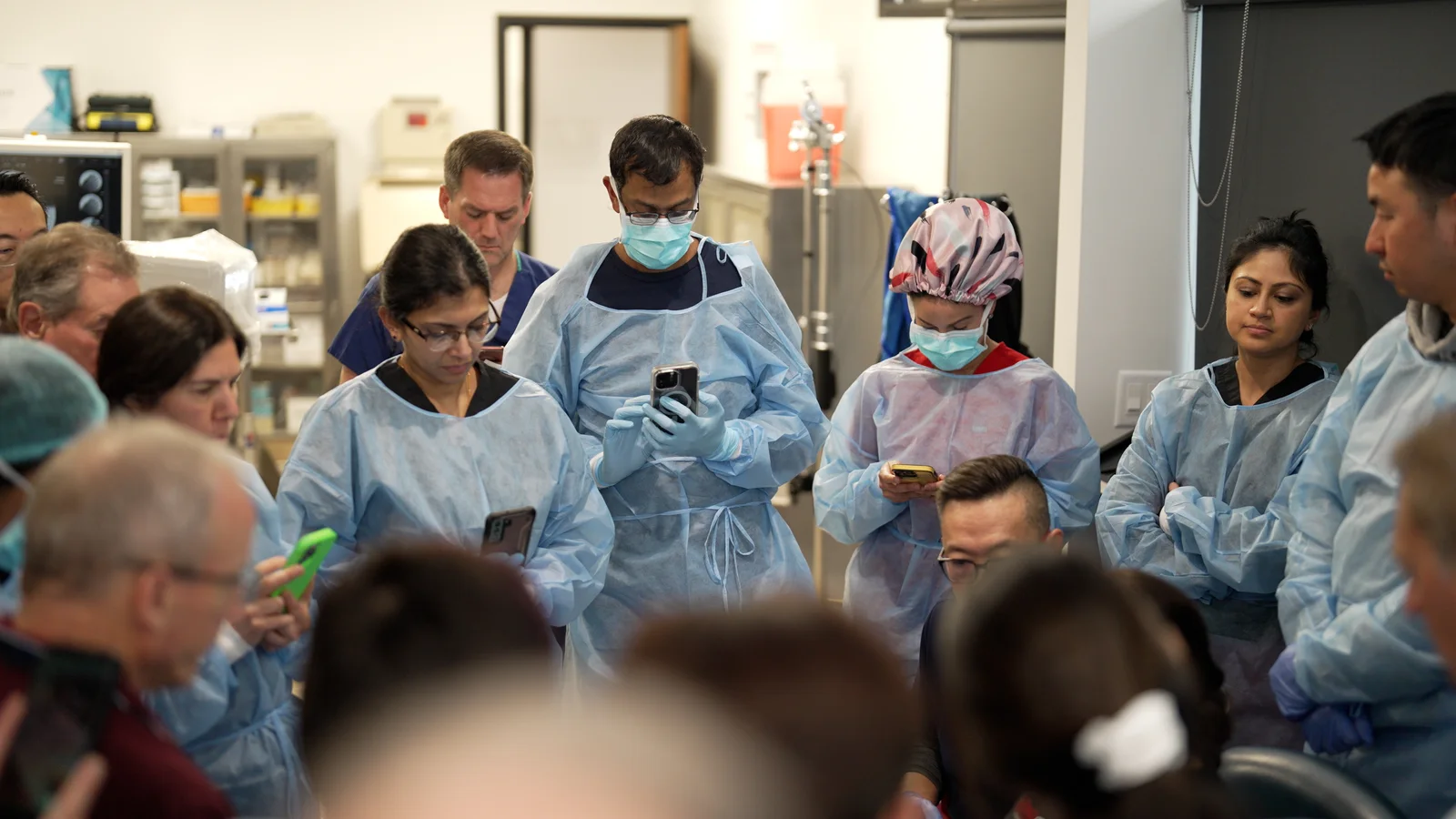 Surgeons watching a demonstration with TJ Ahn in the training room